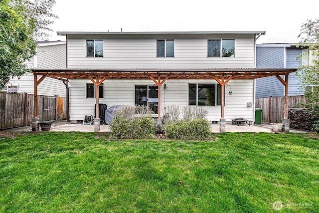 back of property with a fenced backyard, a lawn, a pergola, and a patio