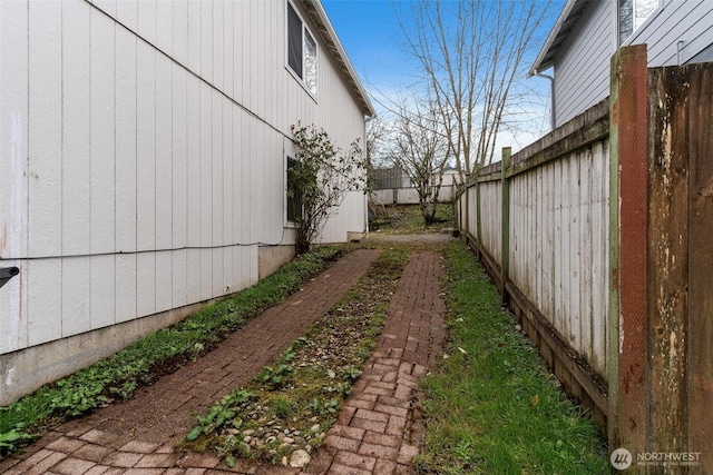 view of side of home featuring a fenced backyard