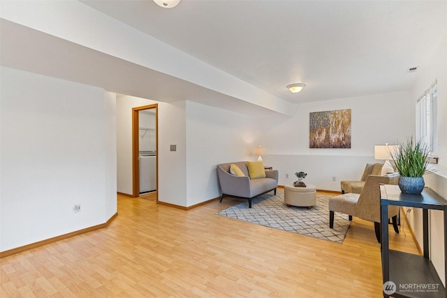 sitting room with visible vents, baseboards, and light wood finished floors