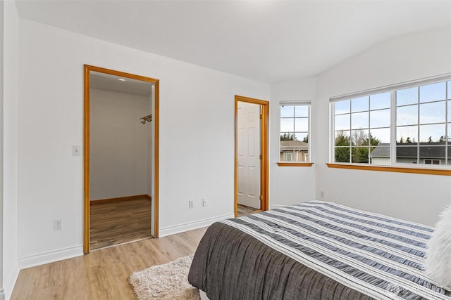 bedroom with wood finished floors and baseboards