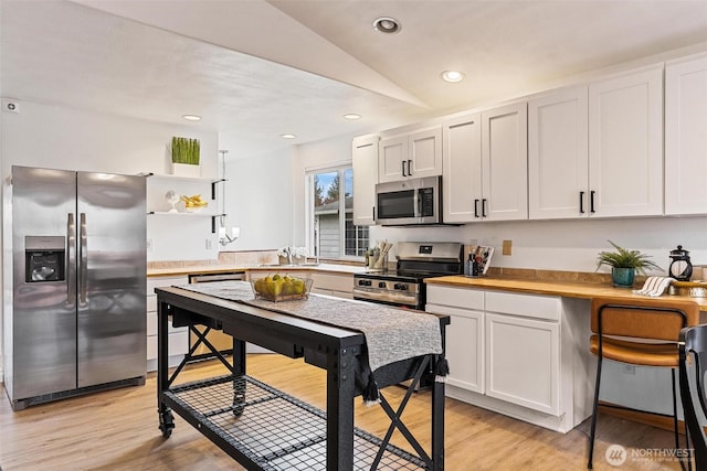 kitchen with open shelves, recessed lighting, a sink, appliances with stainless steel finishes, and light wood-type flooring