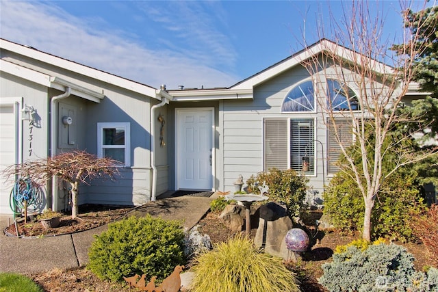 view of exterior entry with a garage