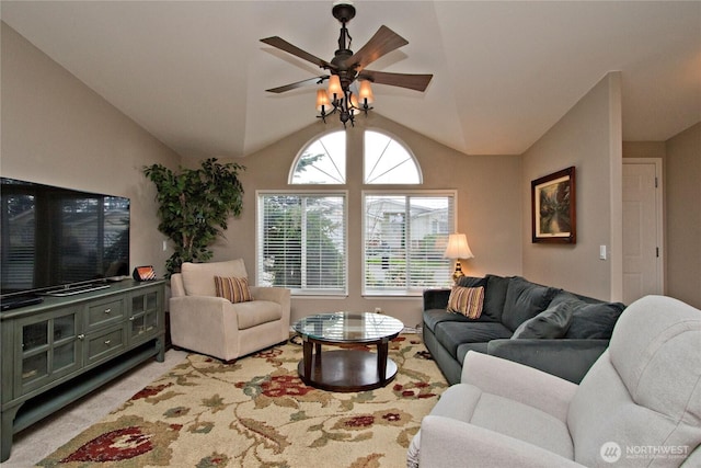 living area with light carpet, lofted ceiling, and a ceiling fan