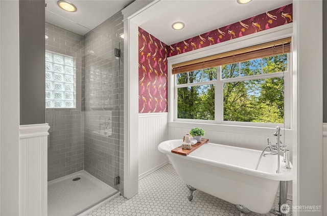 full bathroom featuring recessed lighting, wainscoting, a soaking tub, and a stall shower