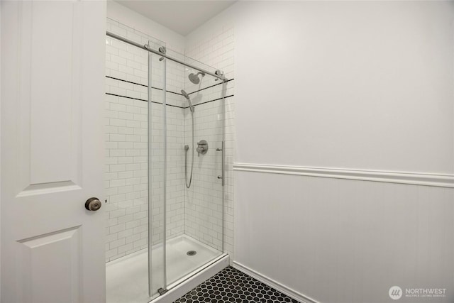 bathroom featuring tile patterned floors and a shower stall