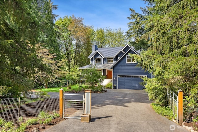 craftsman house with fence, a chimney, a garage, and aphalt driveway