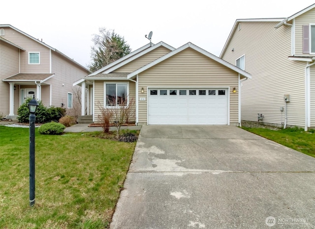 view of front of property with concrete driveway, a garage, and a front lawn