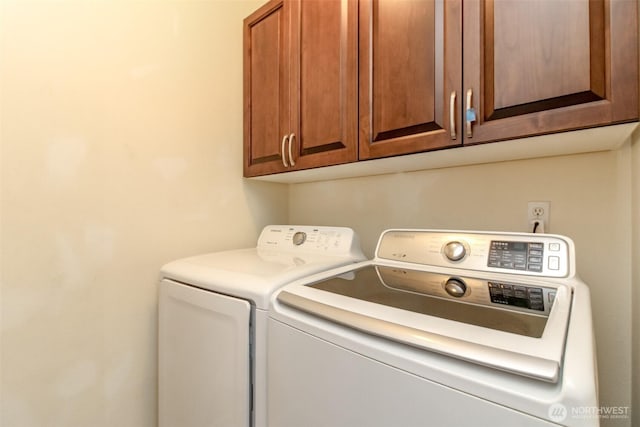 laundry room featuring cabinet space and washing machine and dryer