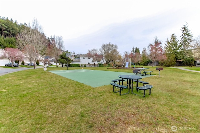 surrounding community featuring community basketball court, a lawn, and playground community