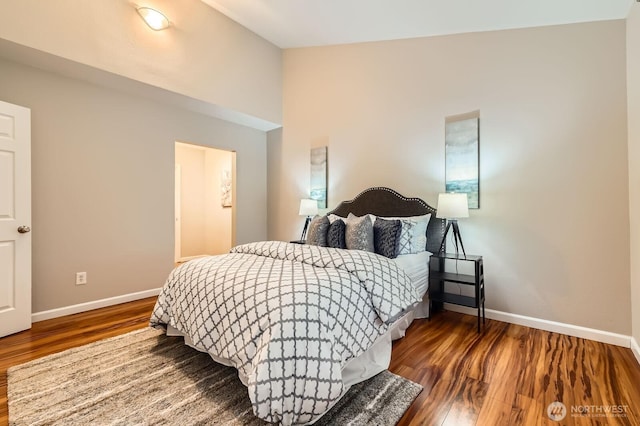 bedroom with wood finished floors and baseboards