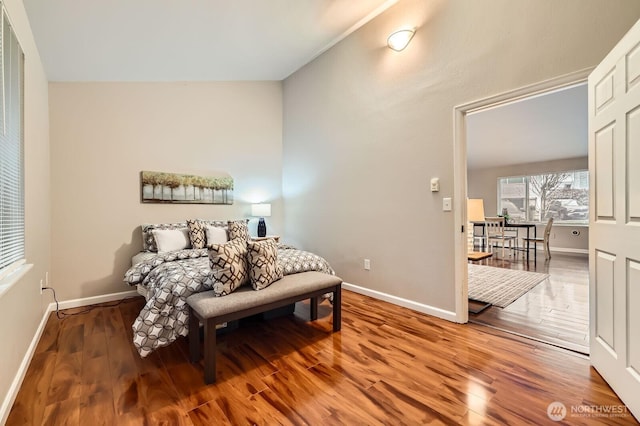 bedroom featuring baseboards and wood finished floors