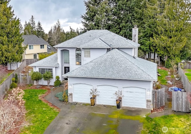 exterior space featuring driveway, an attached garage, roof with shingles, and fence