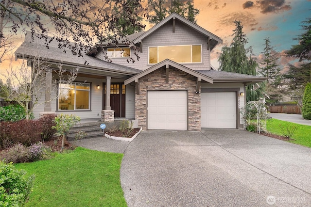 craftsman-style house featuring concrete driveway and stone siding