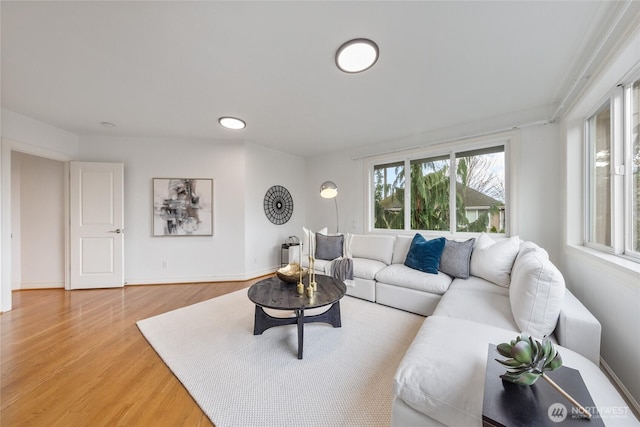 living area with light wood-style floors and baseboards