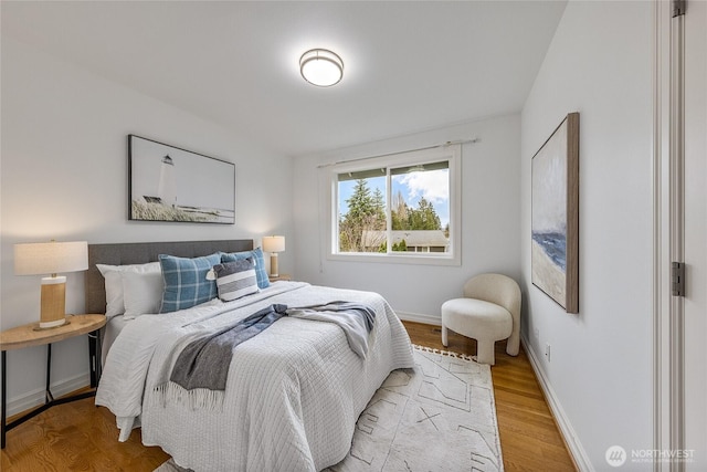 bedroom featuring light wood-type flooring and baseboards