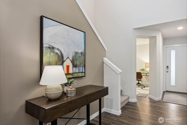 foyer entrance featuring stairway, baseboards, and dark wood-type flooring