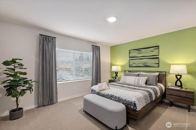 bedroom featuring light carpet and baseboards