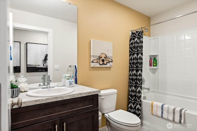 full bathroom featuring shower / bath combo with shower curtain, toilet, and vanity