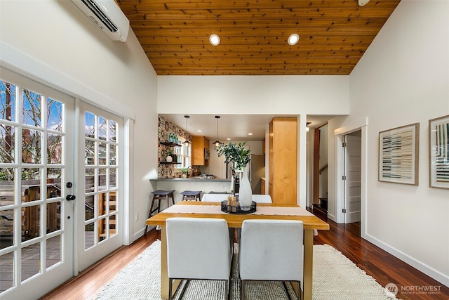 dining area featuring french doors, wooden ceiling, baseboards, and wood finished floors