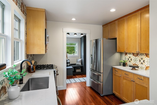 kitchen with dark wood-style floors, recessed lighting, a sink, light countertops, and stainless steel fridge