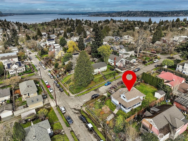 birds eye view of property with a residential view and a water view