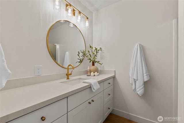 bathroom featuring vanity and baseboards