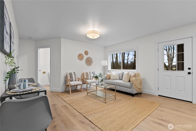 living area featuring light wood-type flooring and baseboards