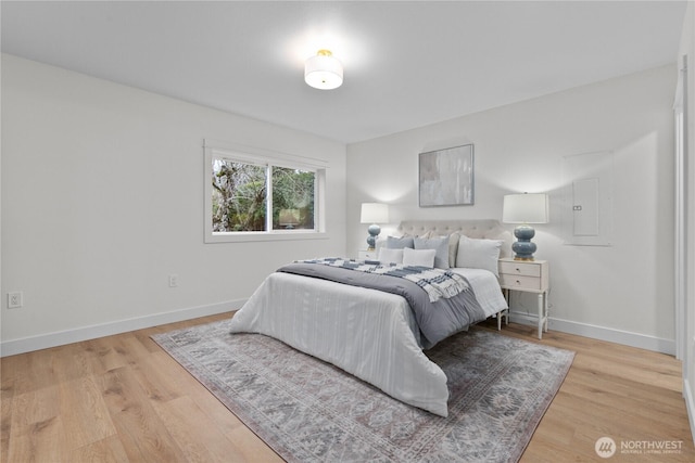 bedroom with baseboards and wood finished floors