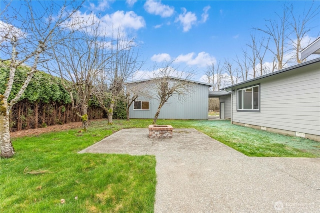 view of yard featuring a fire pit and a patio