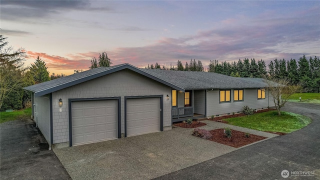 single story home with a garage, driveway, and roof with shingles