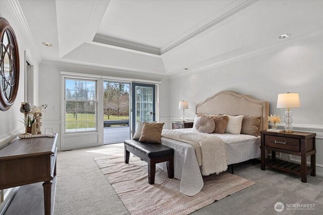 bedroom with access to exterior, wainscoting, light carpet, and crown molding