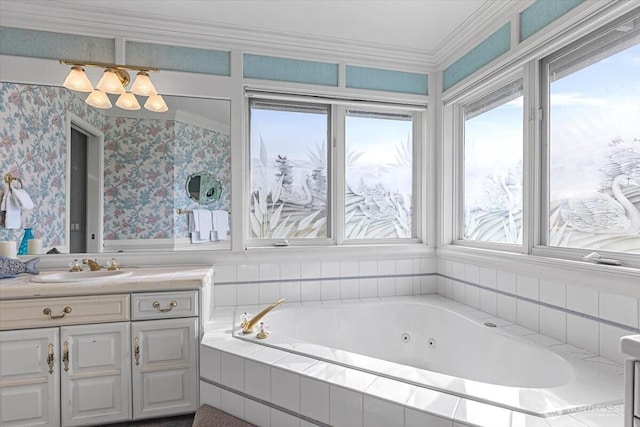 full bath featuring wallpapered walls, crown molding, a jetted tub, and vanity