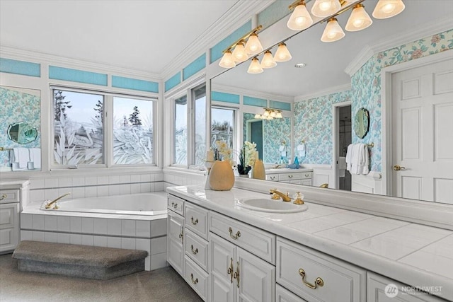 bathroom featuring wallpapered walls, vanity, tiled bath, and ornamental molding