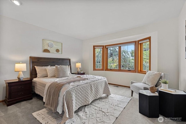 bedroom with visible vents, baseboards, and light colored carpet