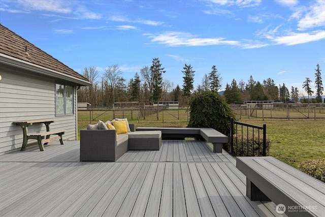 deck featuring an outdoor living space, a lawn, and fence