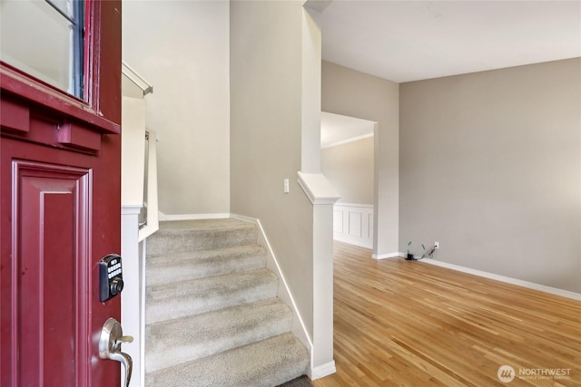 stairway featuring wood finished floors and baseboards