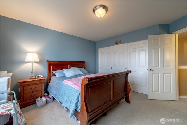 bedroom with a closet and light colored carpet