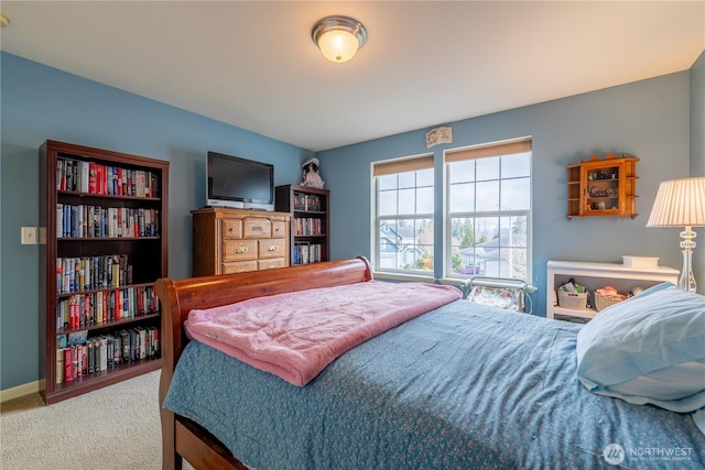 bedroom with carpet and baseboards