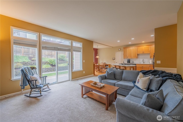 living area with recessed lighting, baseboards, and light carpet