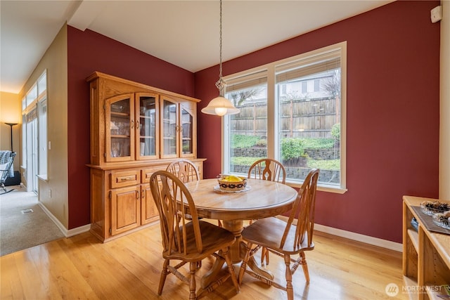 dining space with visible vents, baseboards, and light wood-style floors