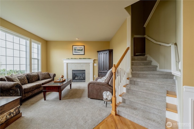 living room with stairway, a fireplace, and wood finished floors