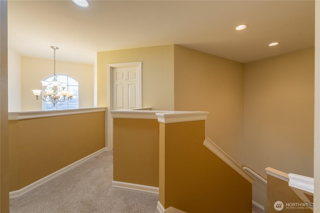 hallway with carpet, baseboards, an inviting chandelier, recessed lighting, and an upstairs landing