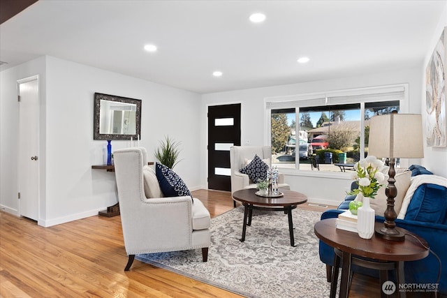 living room featuring recessed lighting, light wood-type flooring, and baseboards