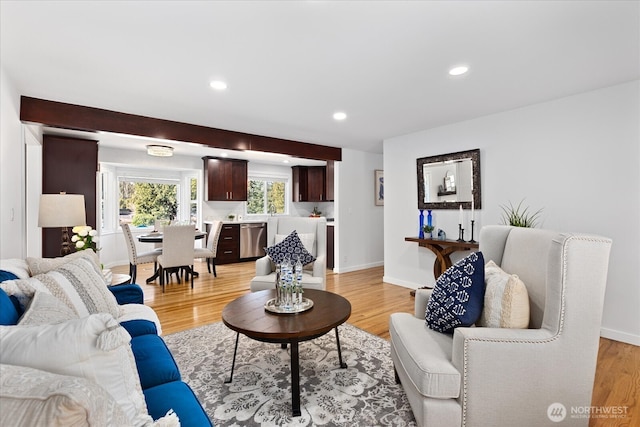 living area with recessed lighting, light wood-type flooring, and baseboards