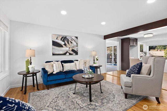 living room with recessed lighting, light wood-type flooring, and baseboards