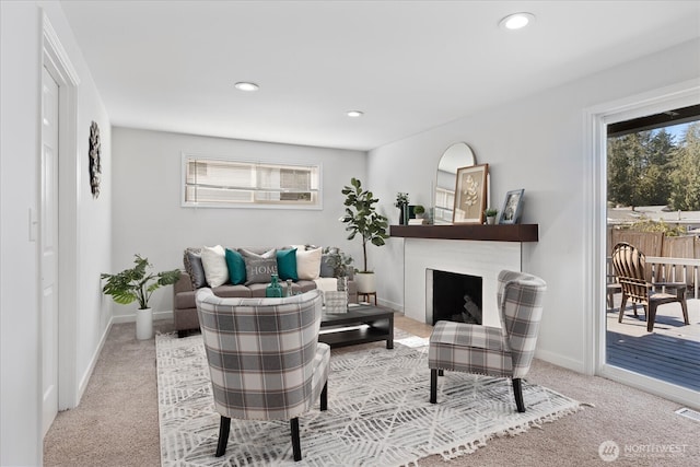 carpeted living area featuring recessed lighting, a fireplace, and baseboards