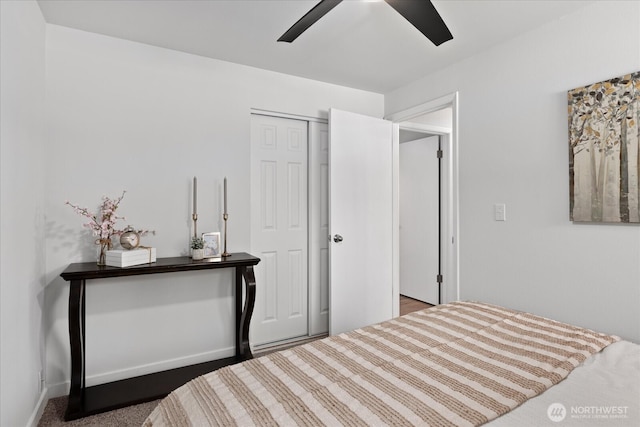 bedroom with a ceiling fan, baseboards, and a closet