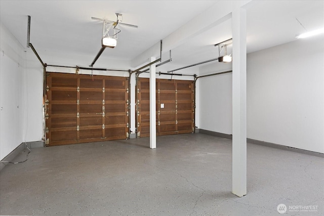garage with a garage door opener and baseboards