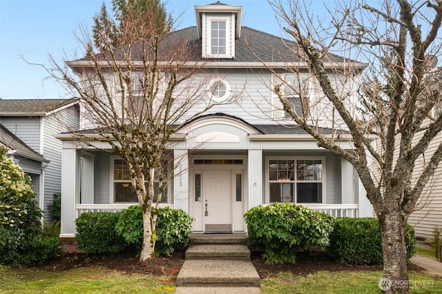 view of front of property with a porch and a shingled roof