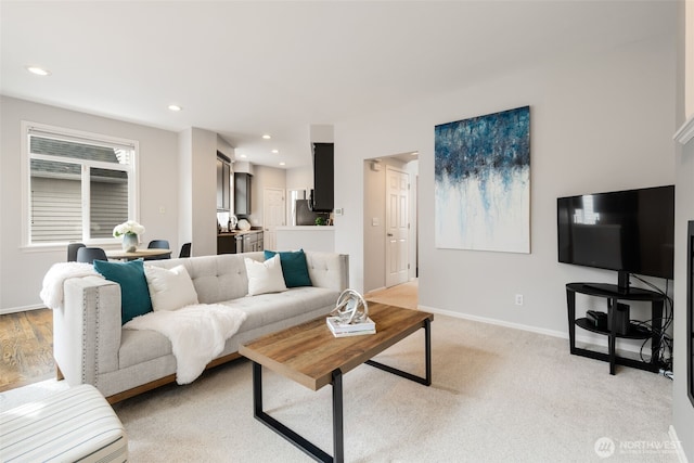 living area featuring recessed lighting and baseboards